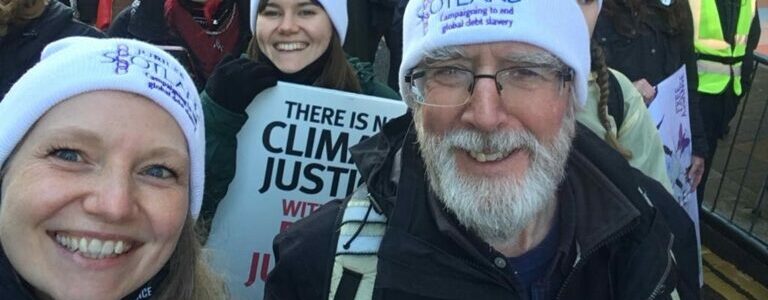 The 2021 Jubilee Scotland team with the Chair of the Board at the COP28 march. They are all wearing Jubilee Scotland hats.